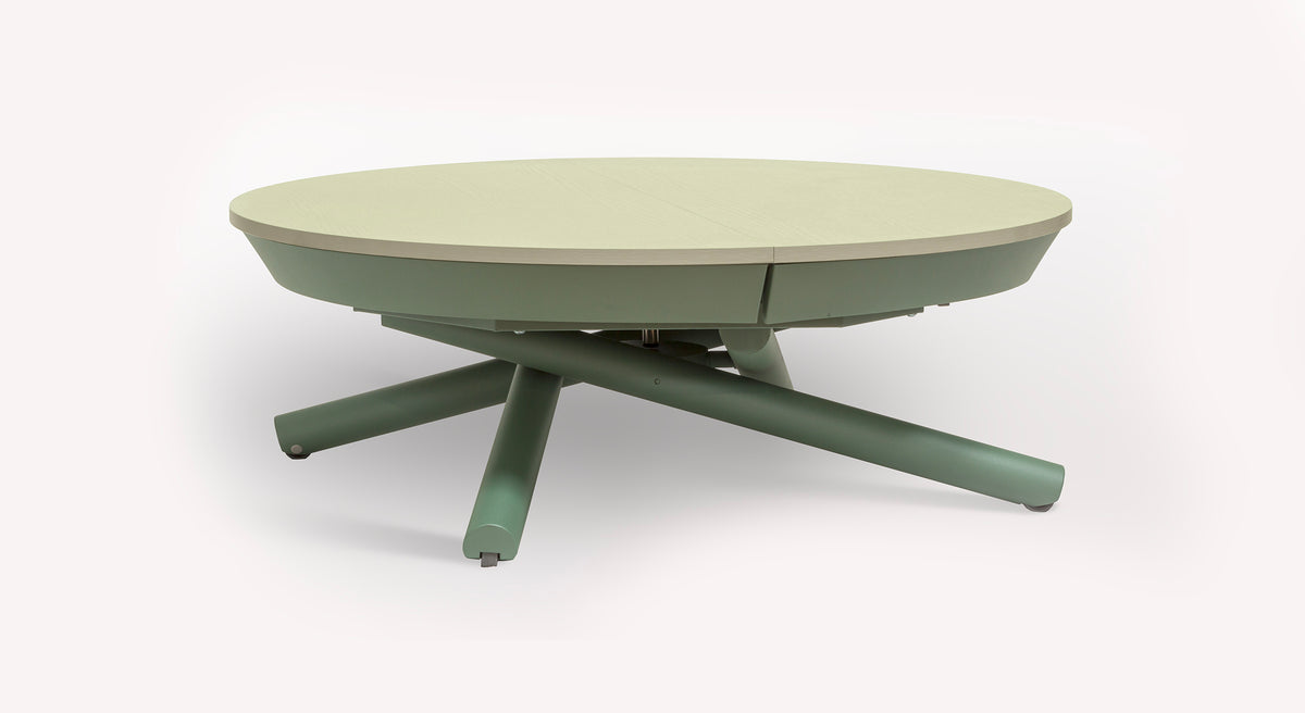 Table extensible Helios, ronde, avec plateau clair et pieds croisés verts