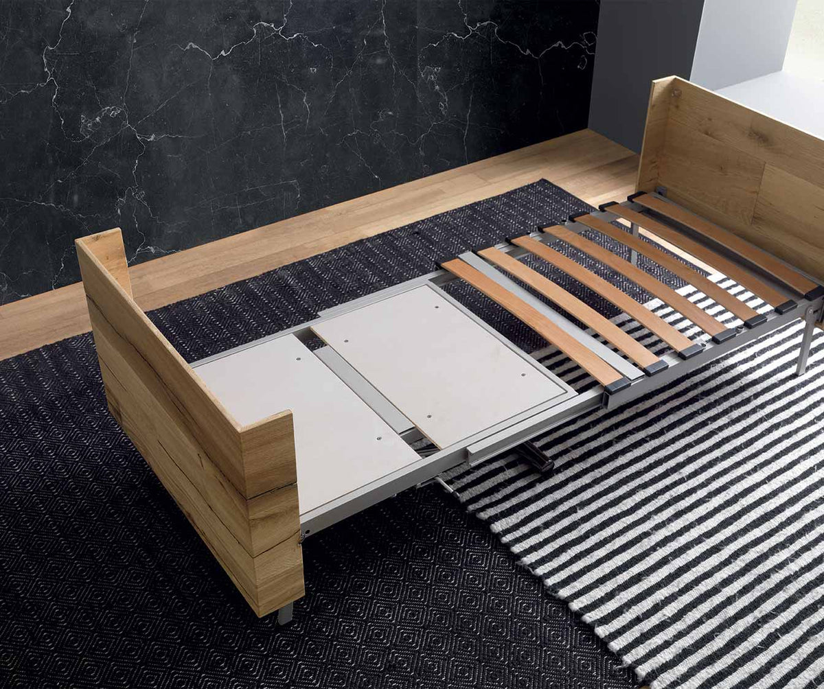 Canapé convertible en bois et métal semi-ouvert avec lattes apparentes et mécanisme visible, présenté dans un intérieur moderne, modèle TAVOLETTO +50 coloris & matériaux.