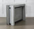Table extensible pliée au design moderne en COMPACT Mélaminé Béton, parfaite pour optimiser l'espace dans un intérieur contemporain.