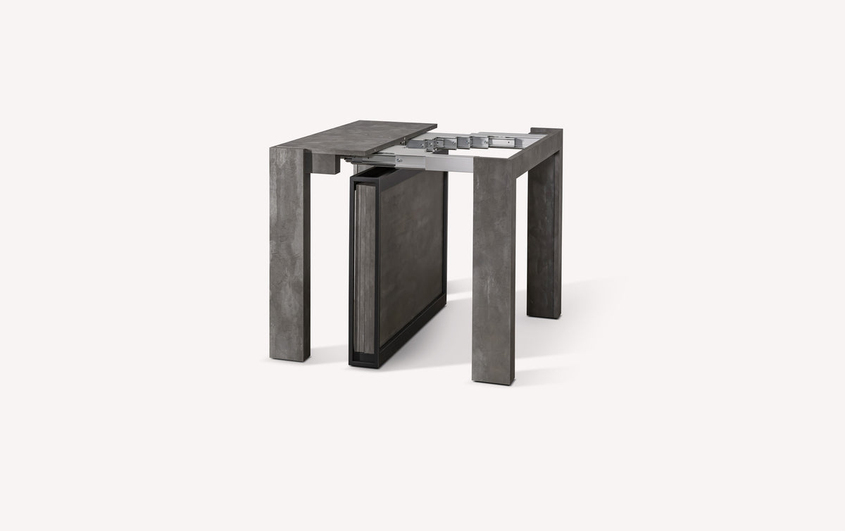 Table extensible compacte en métal gris, semi-ouverte, montrant le mécanisme d'extension