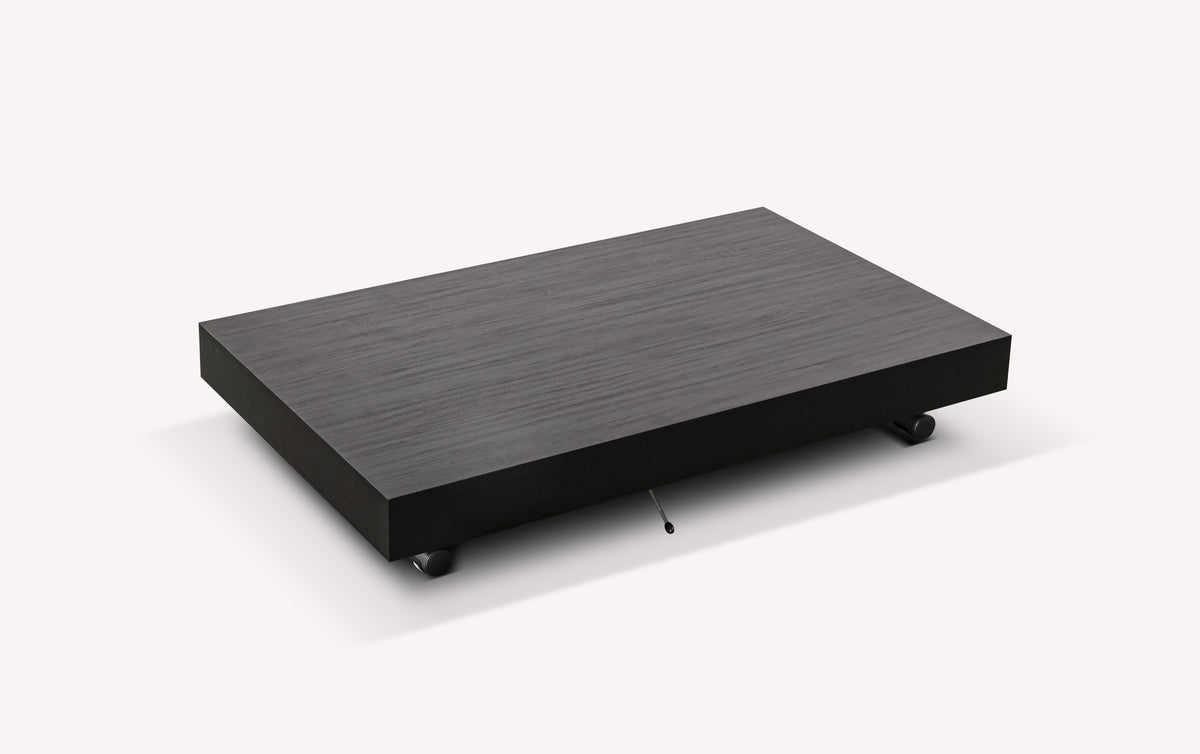 Socle en mélaminé carbone de couleur foncée, modèle MÉLANGE Mélaminé Carbone, adapté pour table extensible avec roulettes discrètes.
