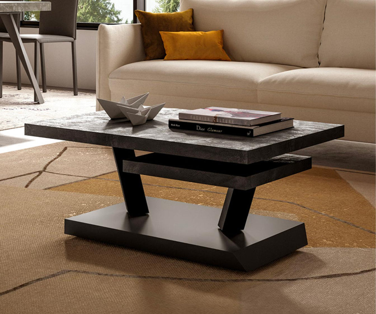 Table basse design avec plateau gris sur piètement noir moderne, posée sur tapis, dans un salon lumineux avec canapé beige orné de coussins colorés, modèle RUMBA Mélaminé Vecchio antico.