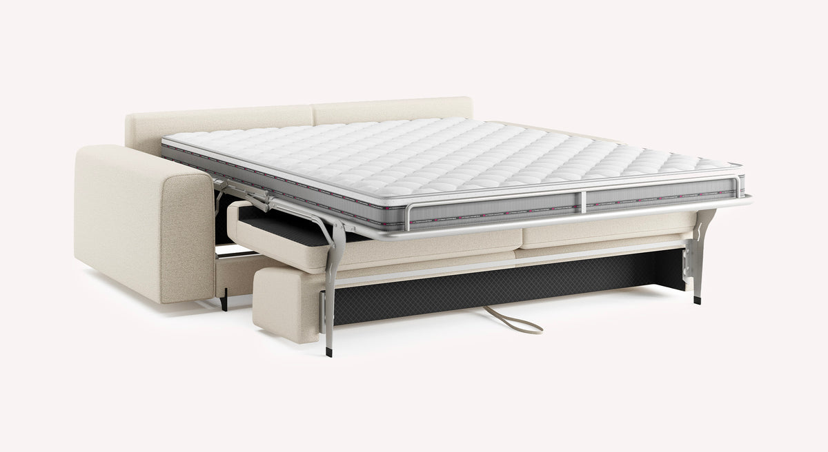 Canapé convertible NELLY Large Innuendo Ivoire avec matelas déplié, offrant un couchage quotidien confortable et un design élégant en tissu ivoire.