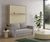 Canapé convertible devant un lit escamotable ETYA Mélaminé Roble aurora Façade biscuit Luna 31 intégré dans un salon moderne avec une table basse ronde, une lampe et une plante verte.