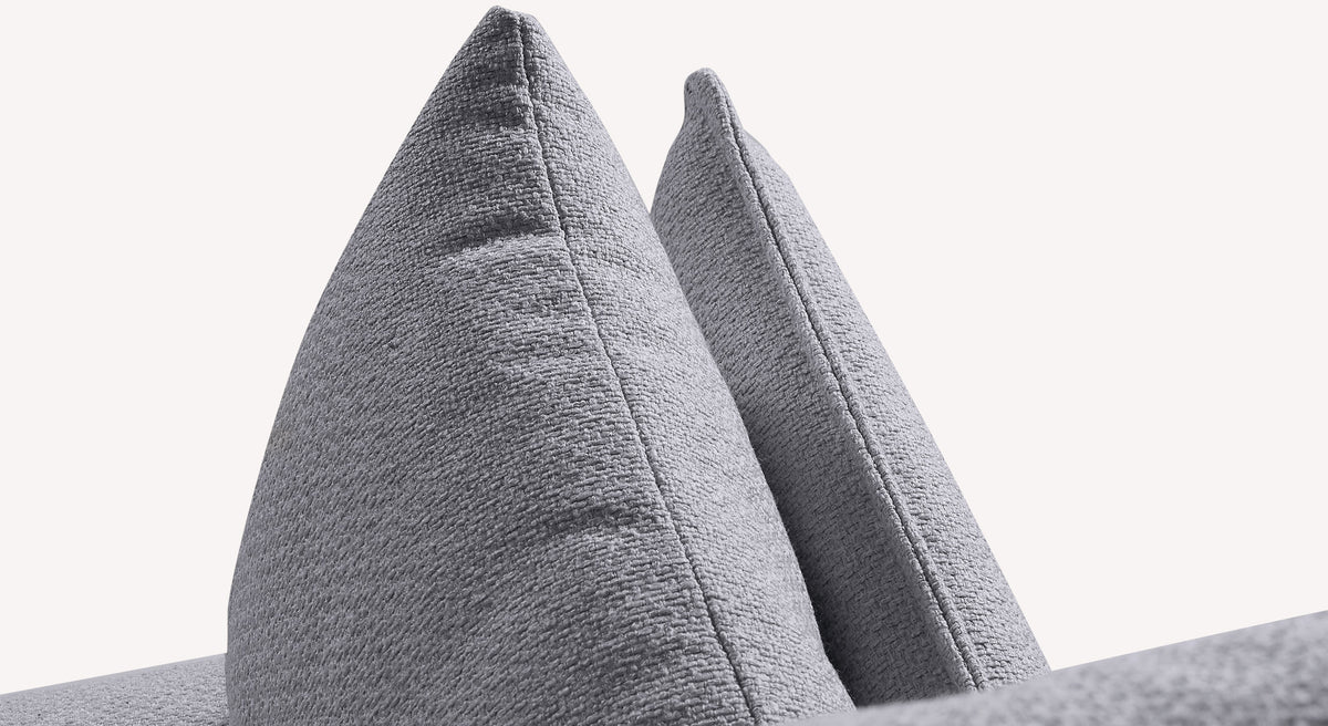 Gros plan sur deux coussins en tissu gris texturé, partie d'un canapé convertible Cody en tissu Bentley Storm