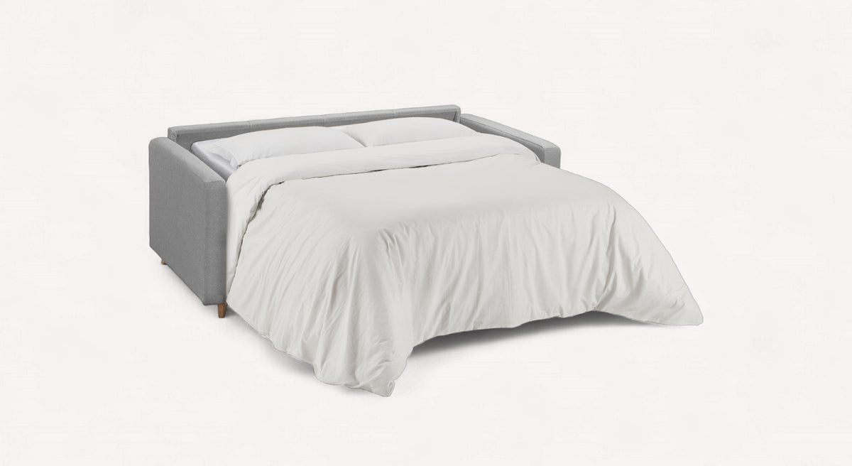 Canapé convertible NOVA Barrel Etain en tissu gris clair déplié en lit avec couette blanche, style moderne et épuré adapté au couchage quotidien.