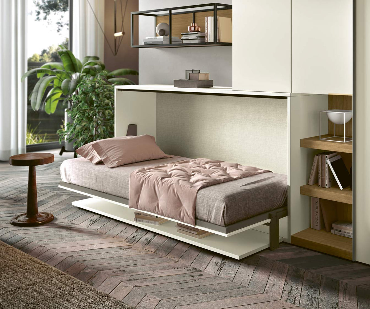 Lit escamotable intégré dans un meuble blanc avec un matelas et une couette rose, dans une chambre lumineuse et décorée avec des plantes, modèle LUCY BUREAU Enfant Mélaminé Blanc.