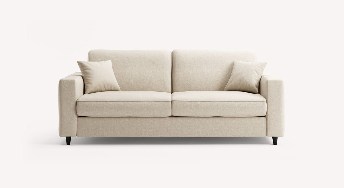 Canapé convertible en tissu ivoire, modèle Alba, avec deux coussins assortis, sur fond blanc