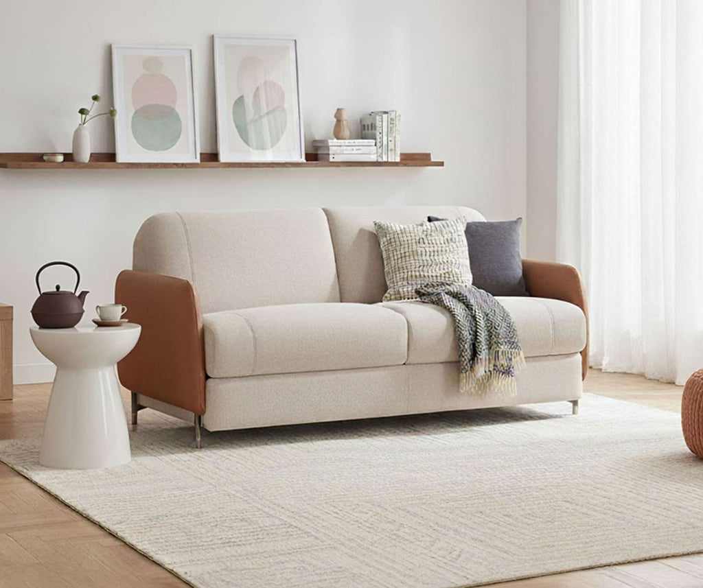 Canapé convertible ECHO Aragon Ivoire Monet 4518 Cognac dans un salon lumineux avec accoudoirs en tissu cognac et assise ivoire, décor moderne et épuré.