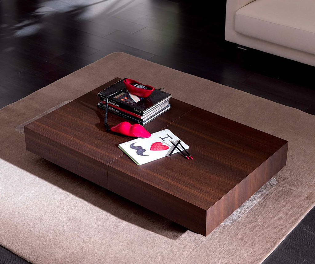 Table basse design BOX LEGNO Plaqué Rovere wild bianco en bois foncé posée sur un tapis clair dans un salon moderne avec un canapé beige visible.