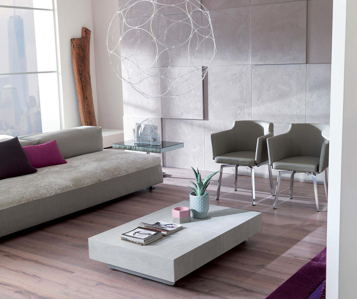 Salon moderne avec canapé et fauteuils autour d’une table basse minimaliste en BOX Verre Extrachiaro, décor épuré et ambiance lumineuse naturelle.