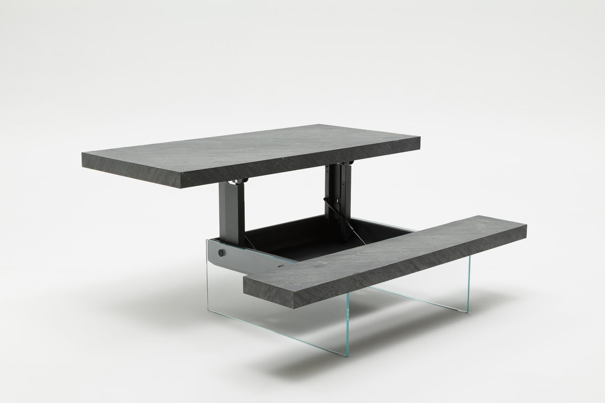 Table extensible moderne en MARKUS Plaqué Rovere vecchio naturale avec plateau surélevé et base en verre transparent, idéale pour optimiser l’espace et allier design et fonctionnalité.