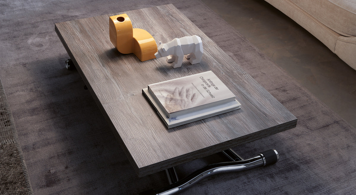 Table basse extensible en bois, modèle Sydney, fermée, avec objets décoratifs et livres sur un tapis gris