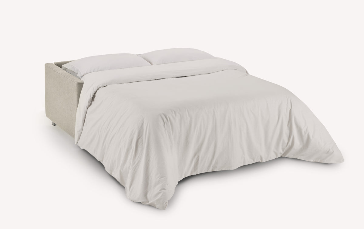 Canapé convertible JIMMY Foster Ivoire ouvert en lit, avec un tissu beige clair et un couchage confortable pour un usage quotidien.