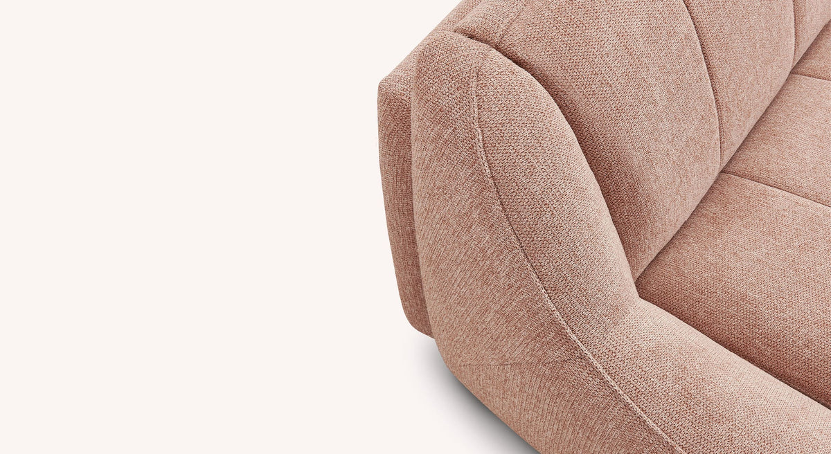 Détail du tissu rose poudré du canapé convertible VENUS Aragon Poudre mettant en avant sa texture douce et son design élégant.