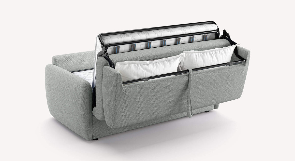 Canapé convertible NEVADA Aragon Etain en tissu gris clair, partiellement ouvert montrant le mécanisme et espace de rangement avec coussins.